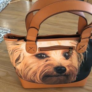 Black and tan shoulder bag with Yorker face